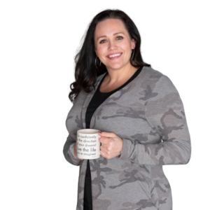Carmen M. Woodland holding a coffee mug with the quote "Go confidently in the direction of your dreams"